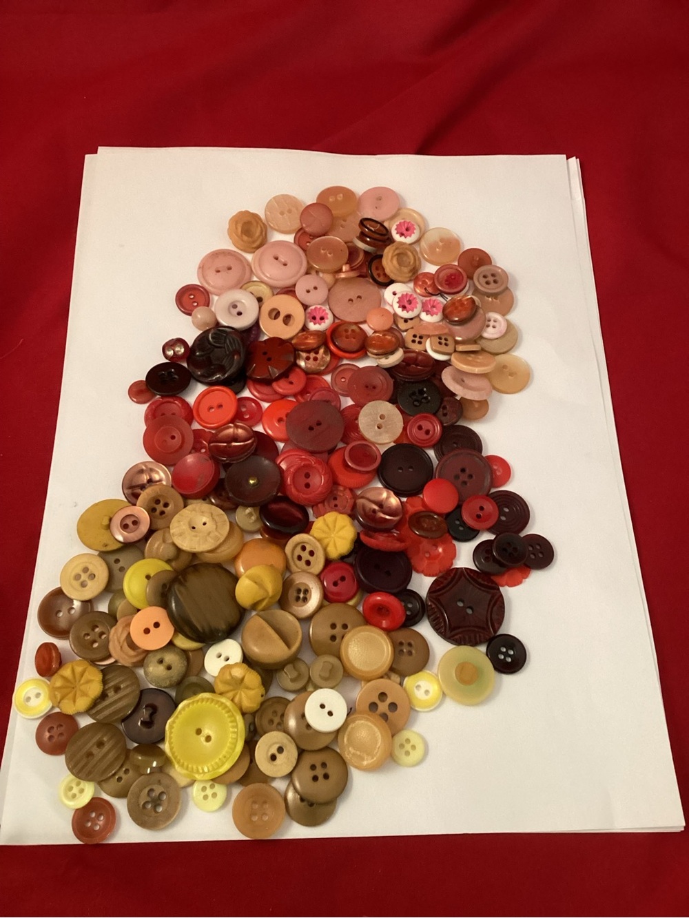 158 grams of yellow, pink and red assorted buttons